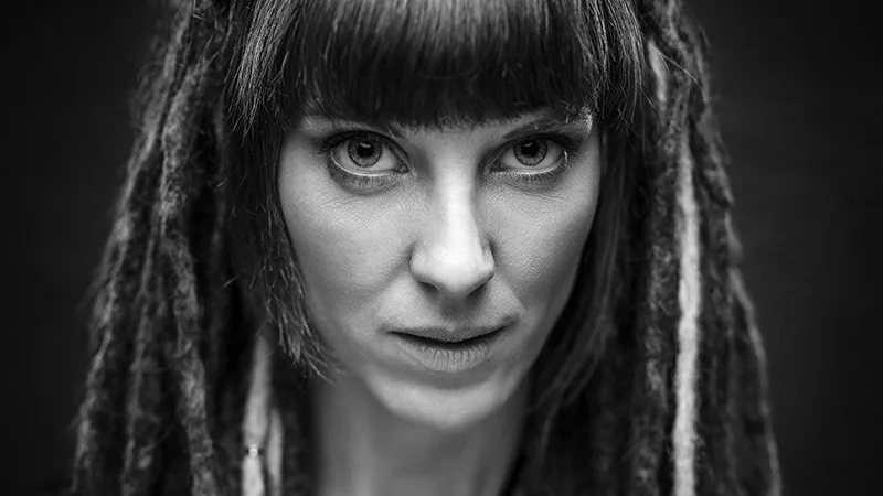 Portrait serré en studio d'une femme au regard intense et expressif en noir et blanc - Article : Le portrait en photographie